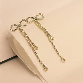 Long bow-shaped earrings made with CZ rhinestones