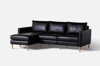 black leather three-seater sofa with L-shape