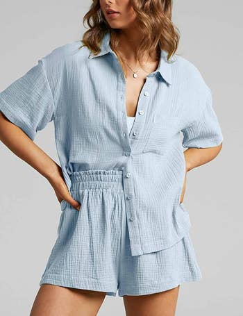 Model in textured blue colored shorts and button up set