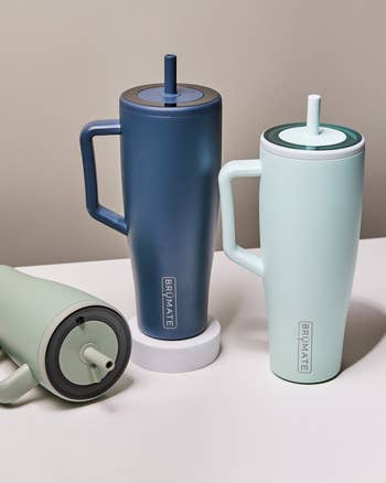 Three insulated tumblers with lids and straws, branded, for keeping drinks hot or cold