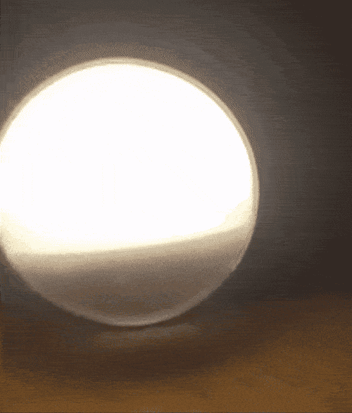 Reviewer gif of the sunset lamp going from bright to a dark orange before shutting off