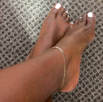 Reviewer wearing the gold elephant ankle bracelet