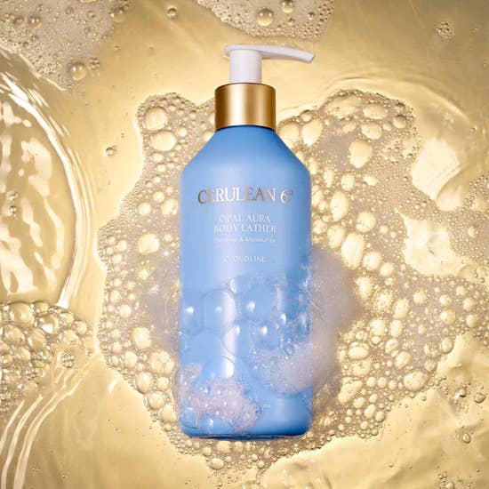 the bottle of body lather surrounded by liquid and bubbles 