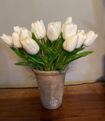 Vase of white artificial tulips displayed for home decor