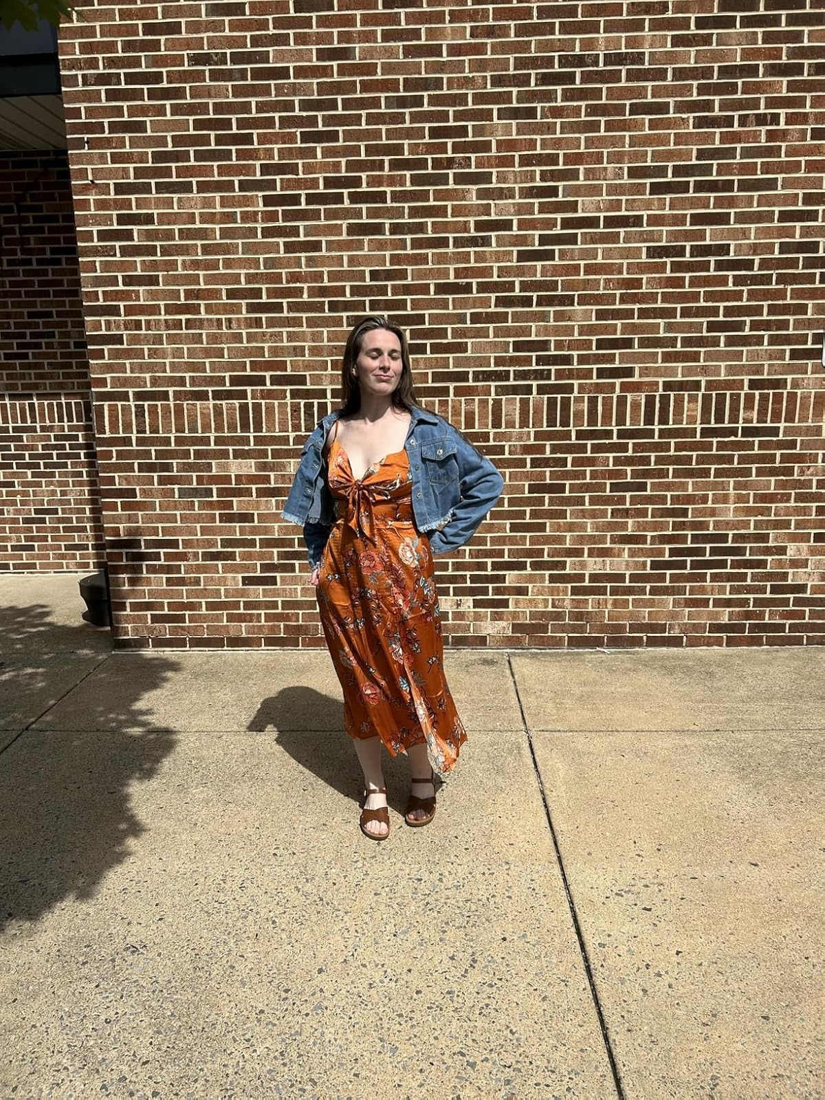 Person successful  floral formal  and denim overgarment   poses confidently extracurricular  connected  a sunny day