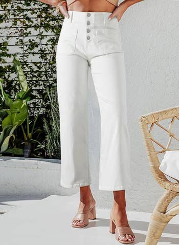 Person in cropped white jeans with button ups 