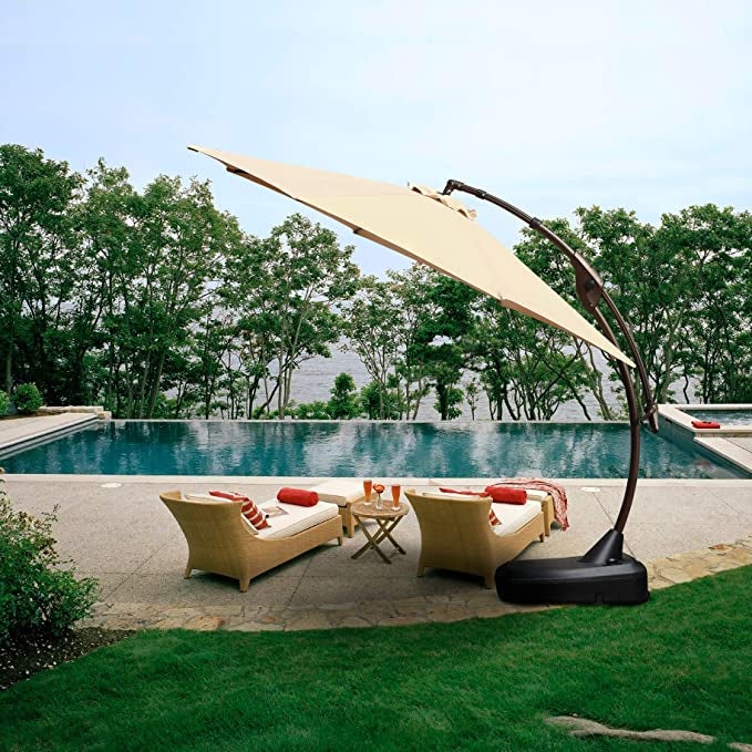 large umbrella opened up next to pool to shade pool chairs