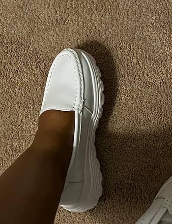 close up image of reviewer wearing the white loafer