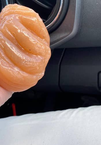 reviewer image of the putty being used to clean the air vent of a car