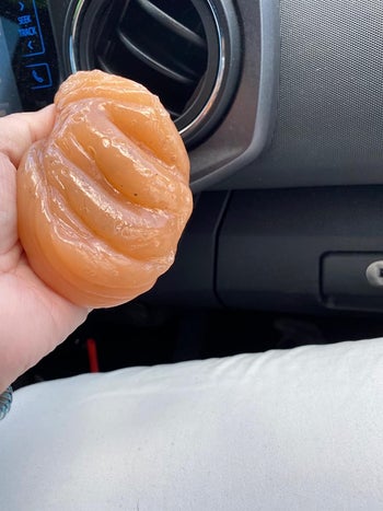 reviewer image of the putty being used to clean the air vent of a car