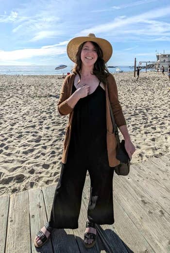 reviewer in the loose black jumpsuit on a boardwalk