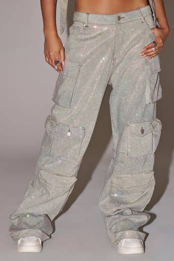 Person wearing sparkly cargo pants with pockets and achromatic sneakers