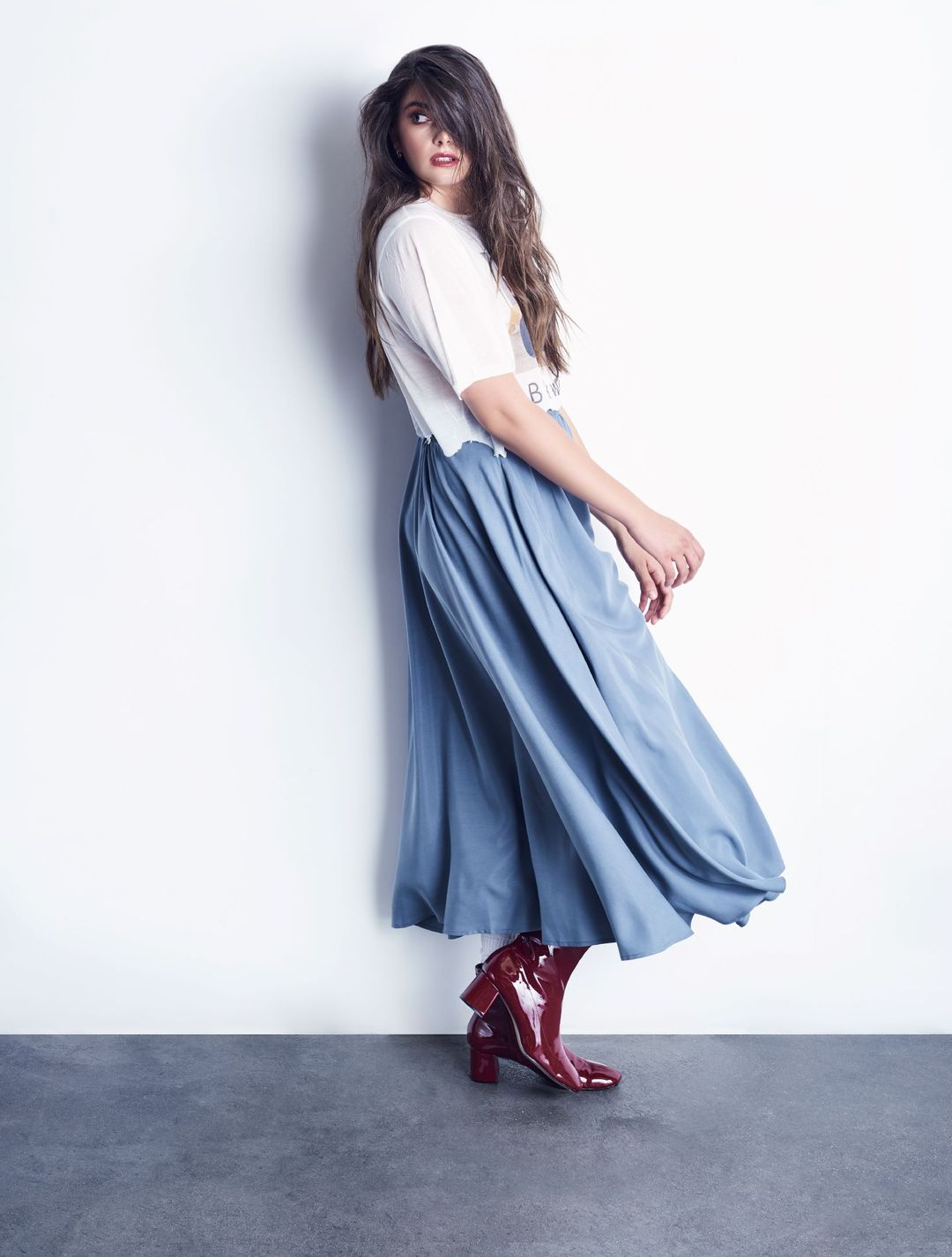 a model in a long light blue maxi skirt