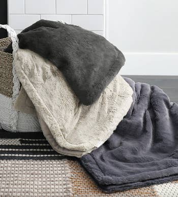 stack of blankets in cream, grey, and blue