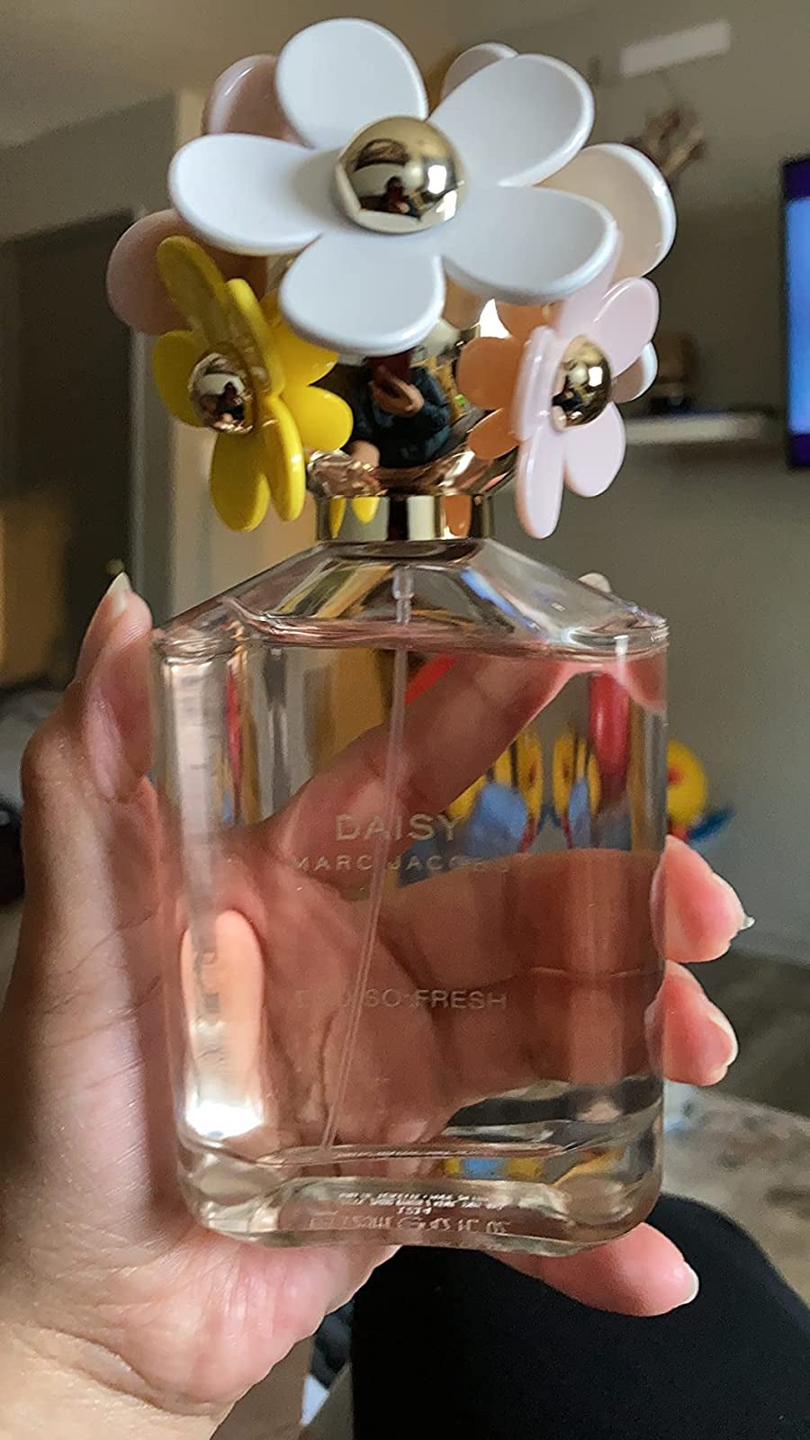reviewer holding perfume bottle