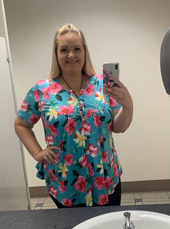 Reviewer wearing bright blue floral top