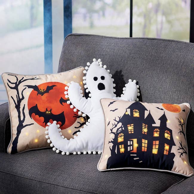 the pom pom ghost pillow on a couch