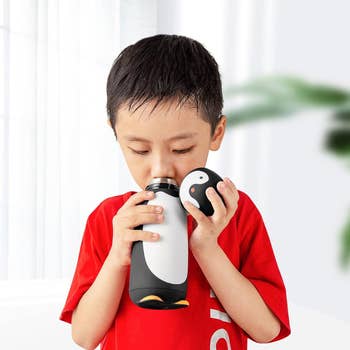 a model drinking from the penguin bottle