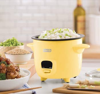 the yellow rice cooker on a kitchen counter