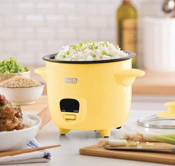 the yellow rice cooker on a kitchen counter
