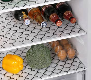 Fridge shelves with black patterned liners