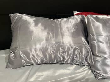 reviewer image of pillows in dark grey satin pillowcases
