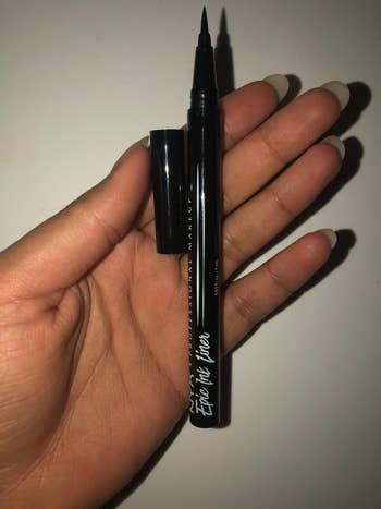 Reviewer holding their Nyx liquid liner
