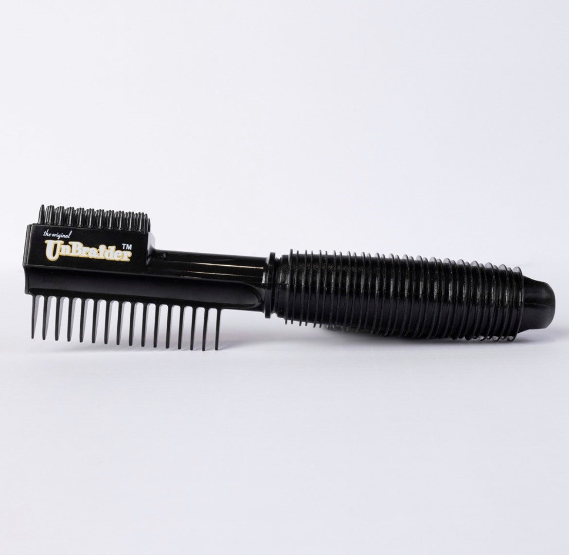 the comb, which has eight teeth on one side and on the other side is a smaller section of more concentrated bristles