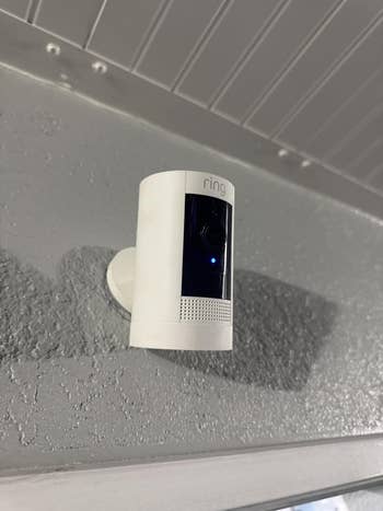 Wall-mounted Ring information    camera with a disposable   camera lens and talker  grille