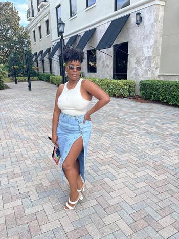 reviewer posing in denim skirt, showing off the slit