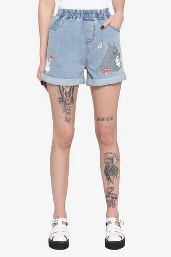model in high waisted shorts with totoro characters on each leg