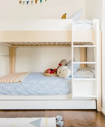 trundle bunk bed in kid's room with ladder
