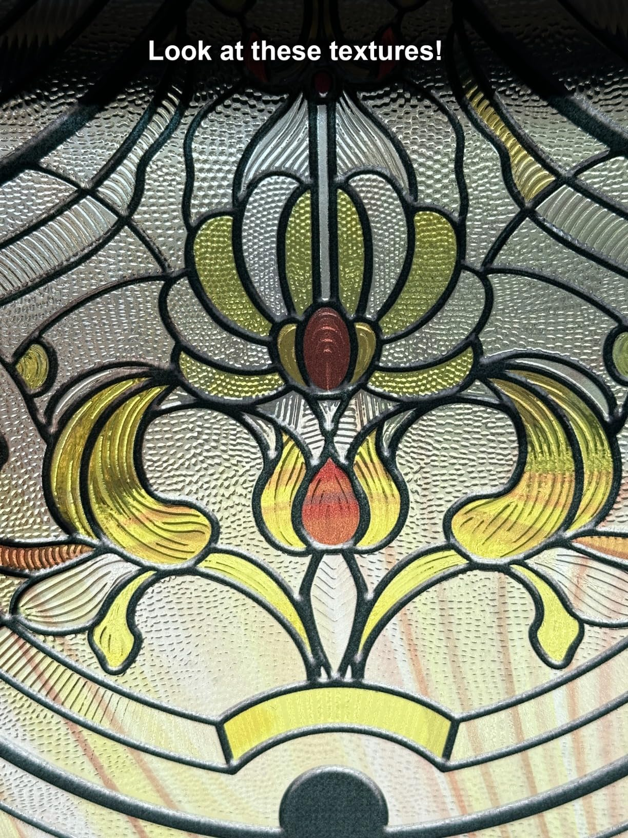 Close-up of decorative glass with intricate textures and floral patterns