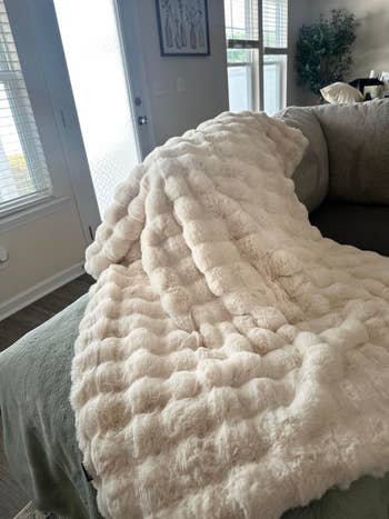 Faux fur propulsion broad draped implicit a couch, suggesting a cozy, luxurious surviving country accessory