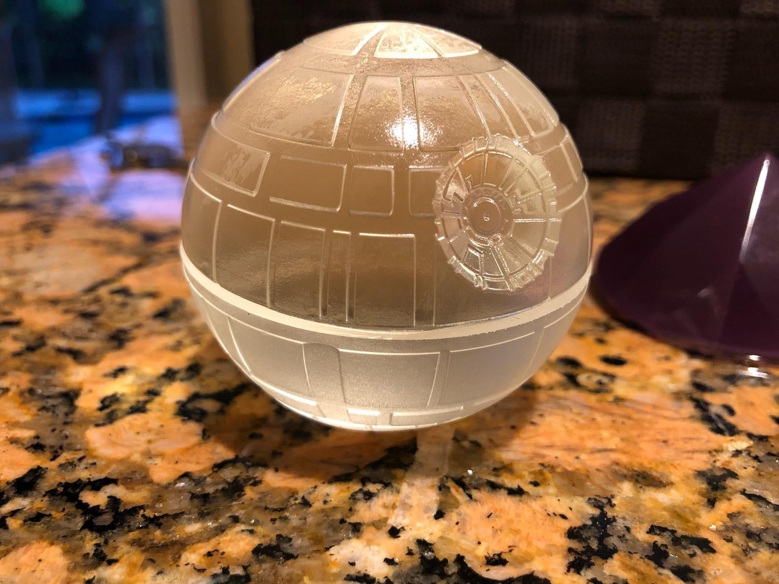 reviewer photo of some death star-shaped iced made using the silicone molds