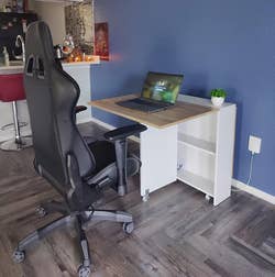 same reviewer's table with one opened and a computer chair pulled up to it being used as a desk