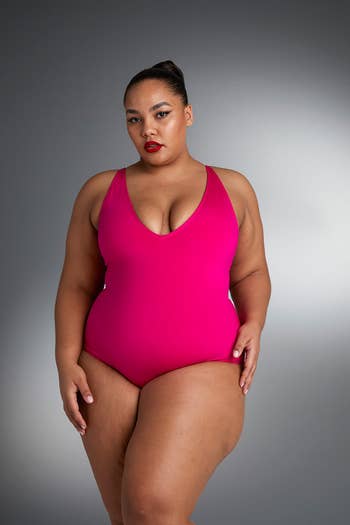 front of a model wearing a hot pink one-piece