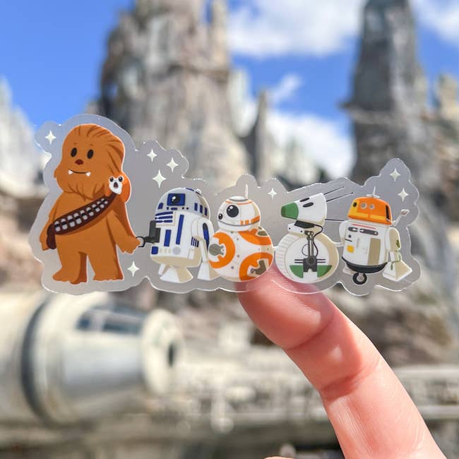 a sticker of chewbacca and an array of famous star wars droids trailing behind him