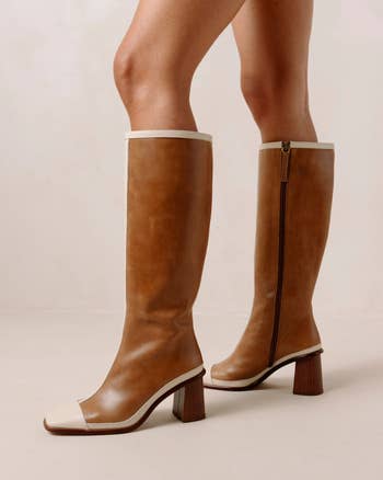 side of a model wearing brown and beige leather striped boots