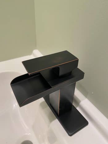 reviewer image of the bronze waterfall faucet