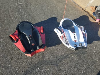 Two of the ride-along toys in red and while