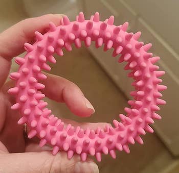 Reviewer holding the pink fidget toy