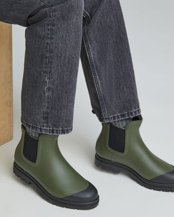 model wearing the green rain boots
