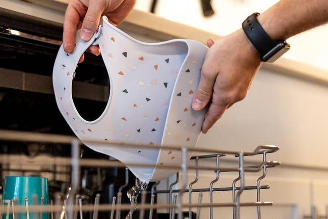 a silicone bib being placed in the dishwasher