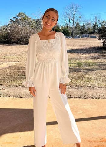 reviewer wearing the long-sleeve jumpsuit in white