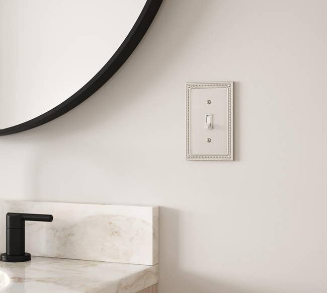 Franklin Brass outlet cover in a satin nickel color and detailed edge