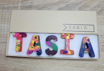 a set of crayons that spell out tasia 