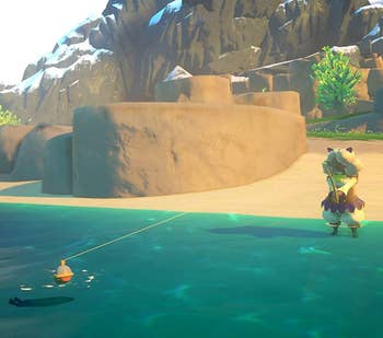 a screenshot from the game showing a character fishing on the beach 