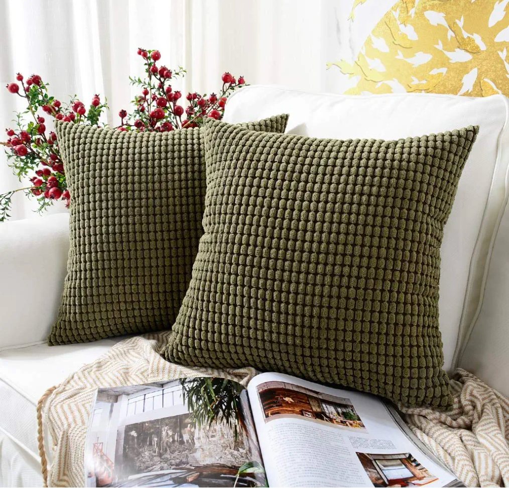 two olive green pillows on a couch