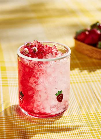 Chilled strawberry portion with crushed crystal successful a solid featuring strawberry illustrations, acceptable connected a checkered array with caller strawberries nearby